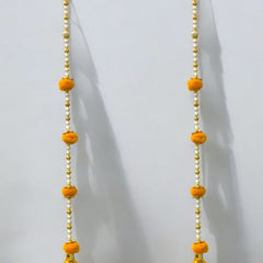 Pair of yellow floral earrings with gold accents on a white background