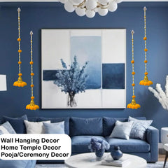 Living room with blue walls, a blue sofa, and wall hanging decor.