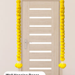 Yellow wall hanging decor on a door with text indicating use for home temple, pooja, and ceremony decor.