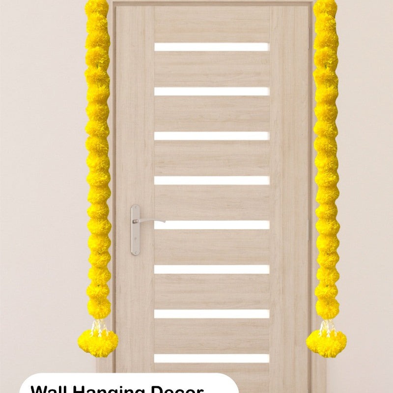 Yellow wall hanging decor on a door with text indicating use for home temple, pooja, and ceremony decor.