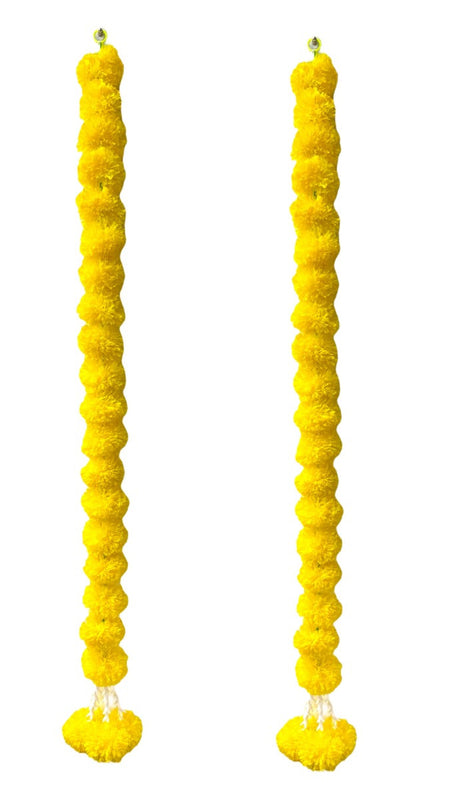 Two yellow textured candles on a white background
