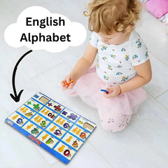 Child playing with an English alphabet learning mat on a white floor.
